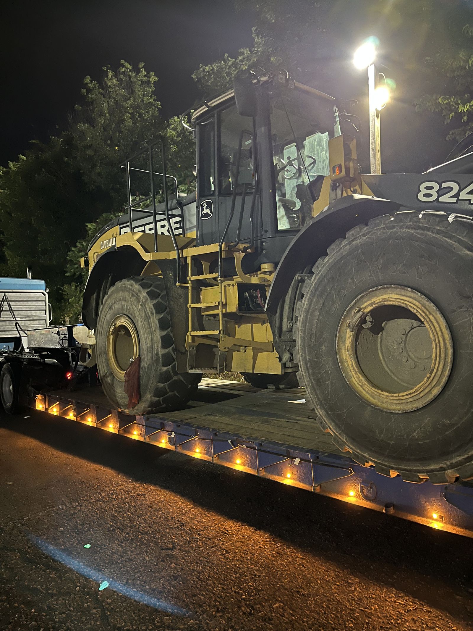 John Deere loader loaded at night